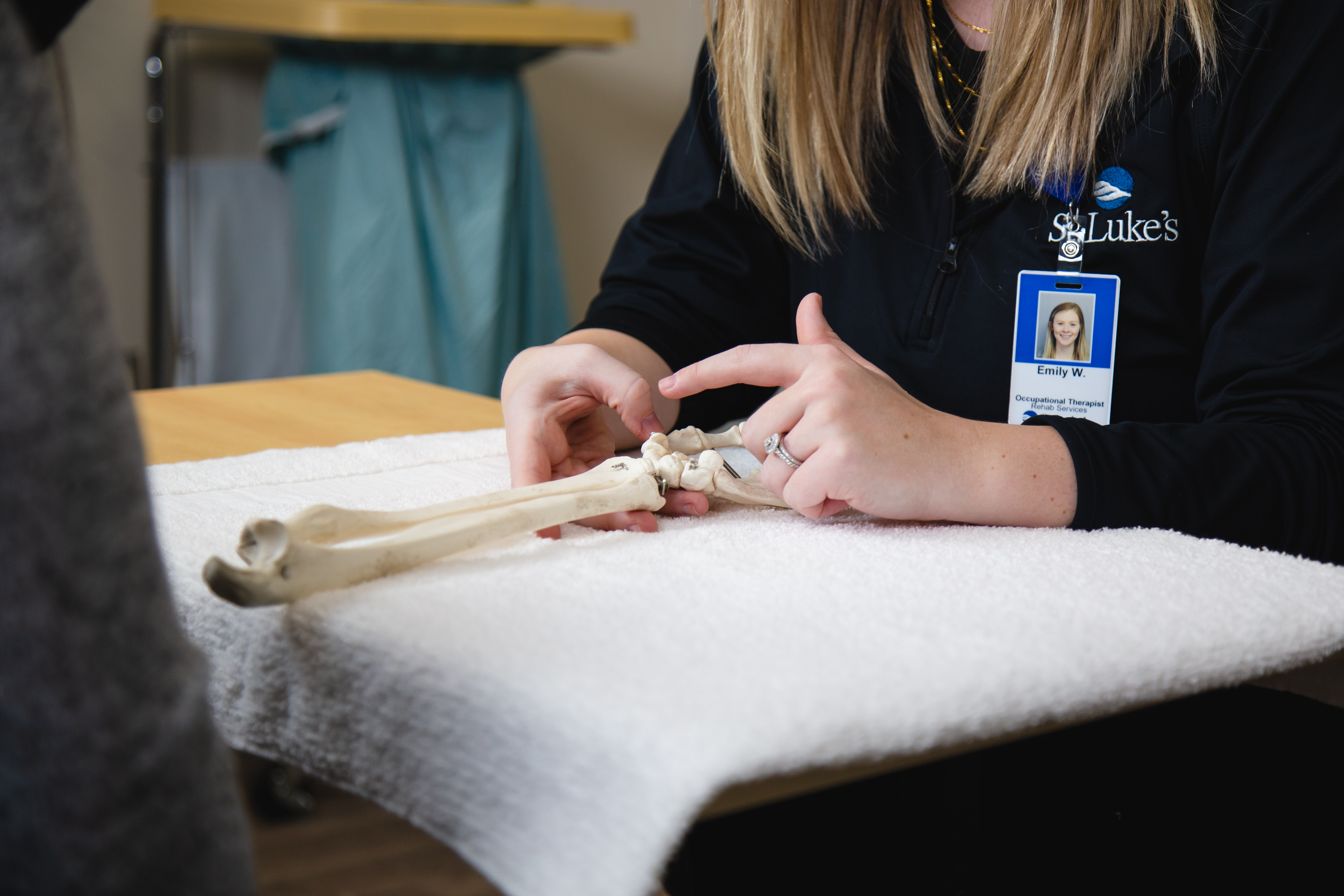 Occupational therapist explains hand issue to patient
