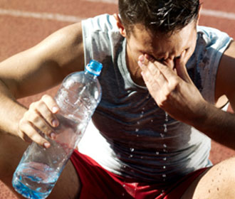 Person Pouring Water On Themselves After Exercising 