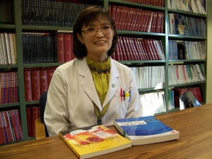 Sunghee Park with the Korean translation of Pharmaceutical Care Practice: The Clinician's Guide (right) and her own book, Pharm D and Precepting (left).