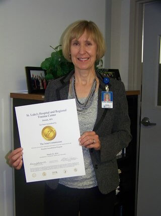 Kathy Johnson, St. Luke's Director of Quality Management, displays The Joint Commission Accreditation Award.