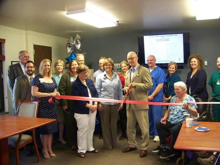 Dr. Samuel Laney, Medical Director of St. Luke's Inpatient Rehabilitation Unit, cuts the ribbon to the newly remodeled unit with the Duluth Chamber.