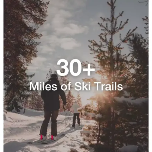 Family cross country skiing with text overlay that says "30+ miles of ski trails."
