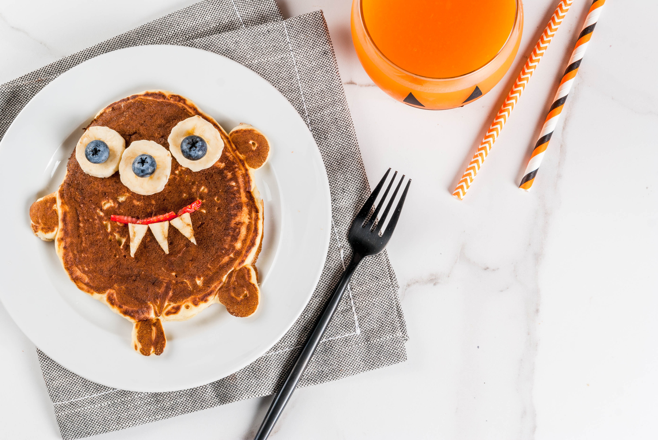 Monster pancake sitting on a table with a fork