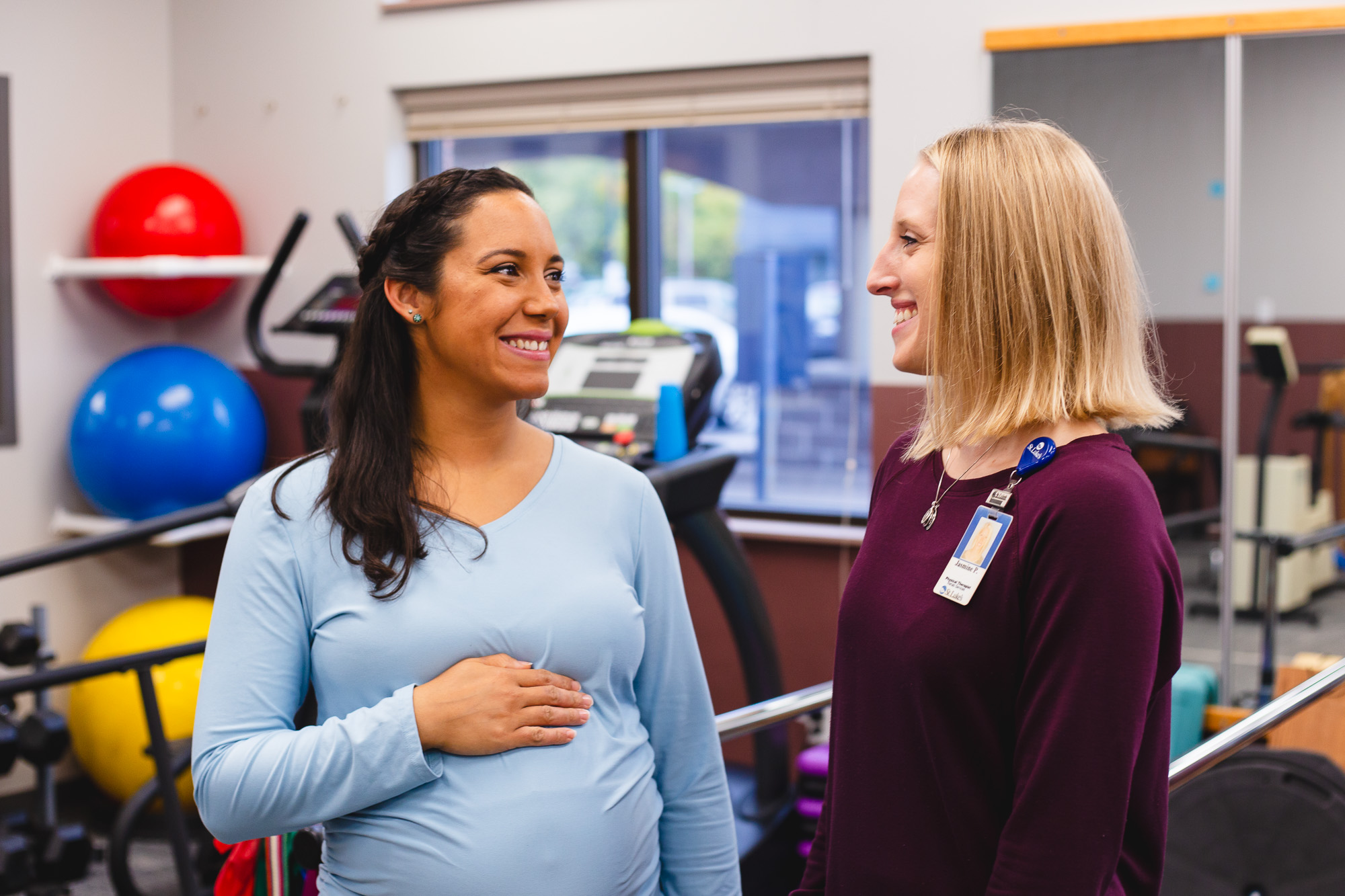Pregnant patient looks at physical therapist