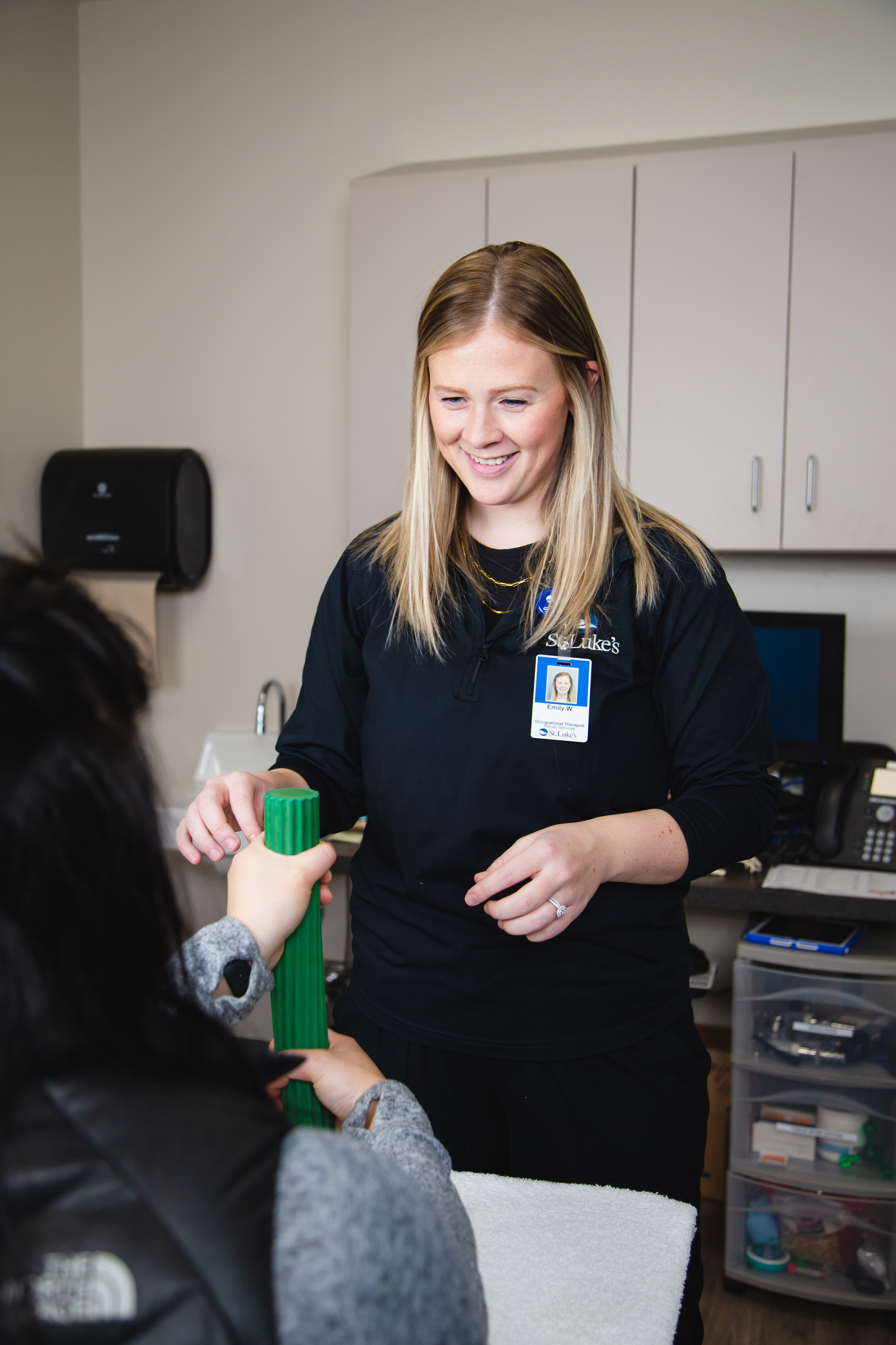 Occupational therapist explains hand issue to patient