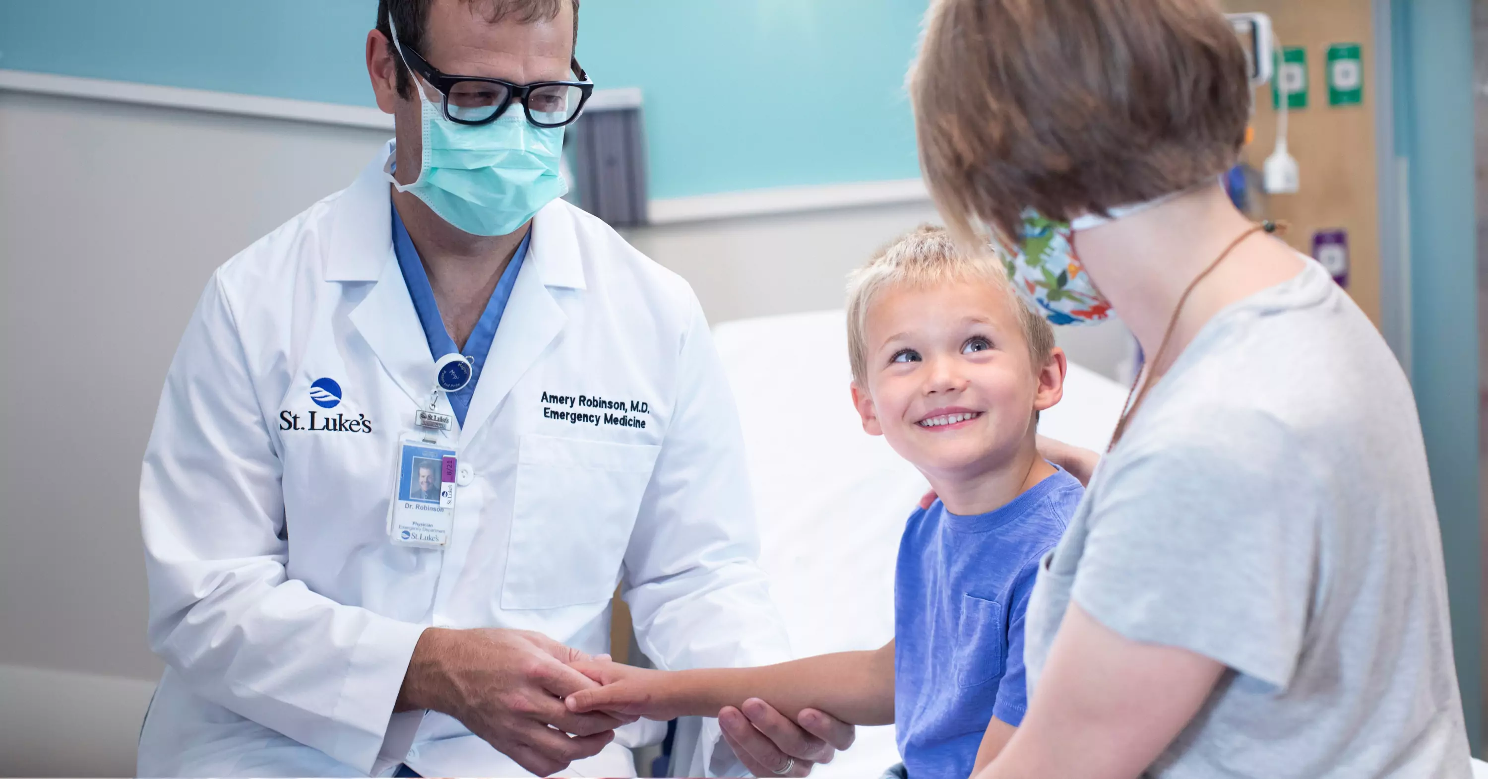 Emergency doctor helping child and mother.