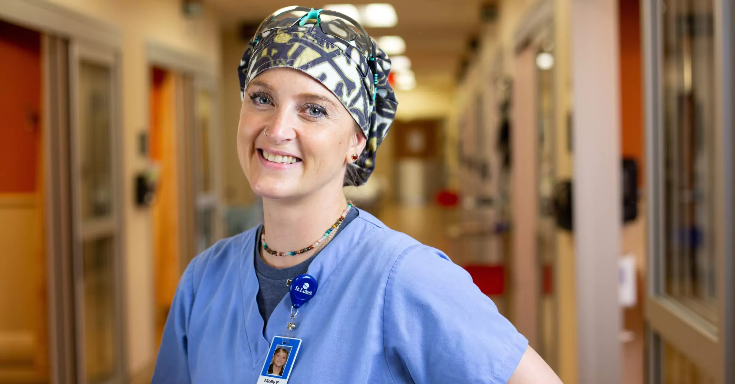 Surgical Technologist smiling in a surgery hallway at St. Luke's in Duluth, MN