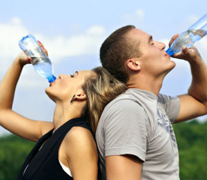 Couple drinking water back to back
