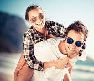 Couple wearing sunglasses on a beach 