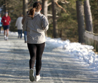 Person Running Down A Snowy Path