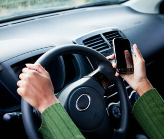 Person Driving and Holding Their Phone