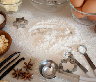 Flour on a table with cookie cutters 