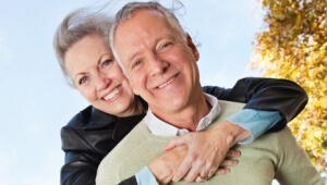 Older couple hugging and smiling