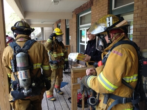 Fire Fighters Standing Outside of a House