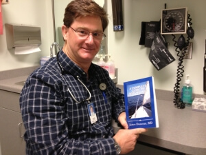 Dr. Donovan Holding His Book