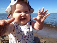 A Baby Sitting on the Beach