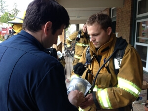 Fire Fighters Standing Outside of a House