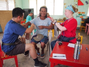 Anna Rathbun offering medical aid to typhoon survivors