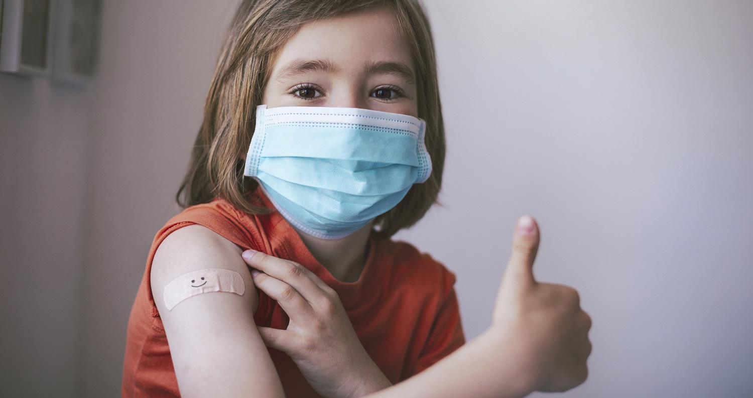 child with bandage and thumbs up