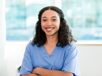 A hugh school student observer in scrubs.