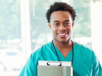 A male student in scrubs.